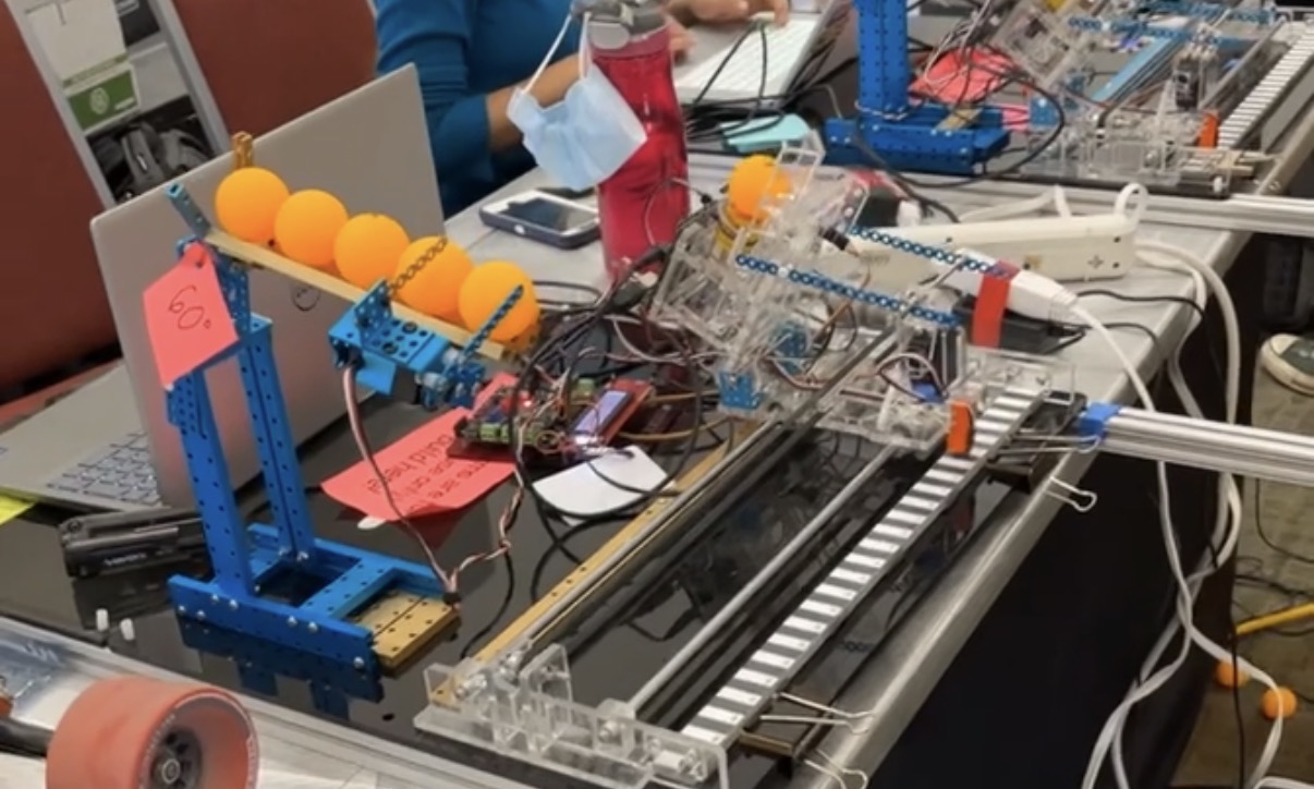 Projectile launcher robot with automated reloading mechanism on the left and launching mechanism on the right